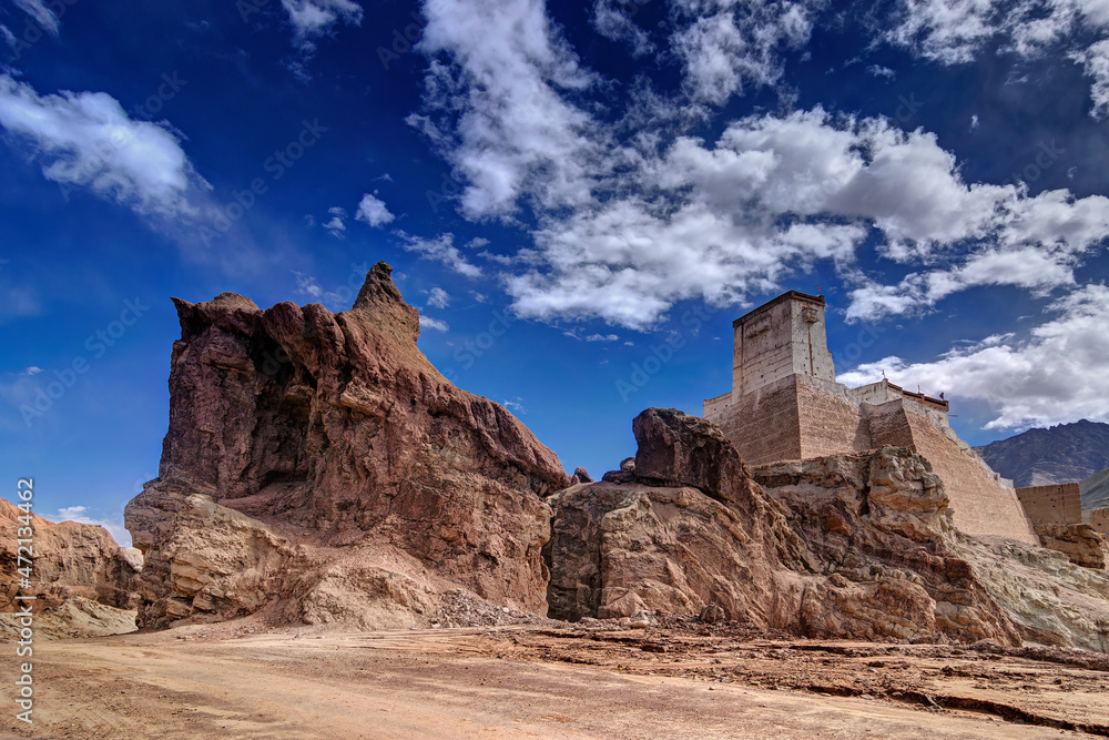 Ruins and Basgo Monastery surrounded with stones and rocks , Blue sky with clouds in the background, Himalayan Mountain range, Leh, Ladakh, Jammu and Kashmir, India