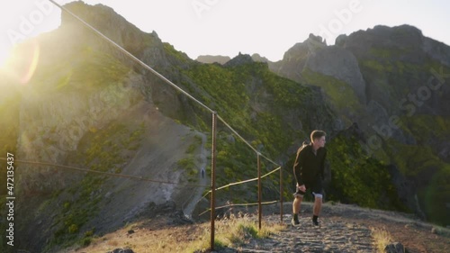Man climbing beautiful PR1 Pico do Arieiro - Pico Ruivo trail; Madeira Portugal