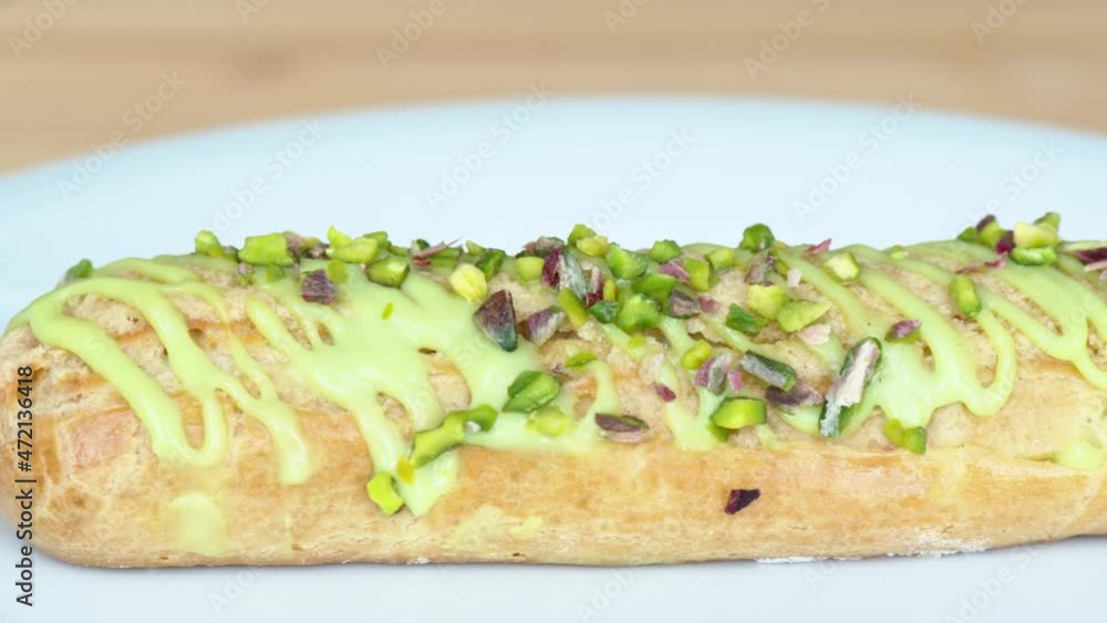 White eclair dessert with fistic nuts and cream White eclair dessert with fistic nuts and cream