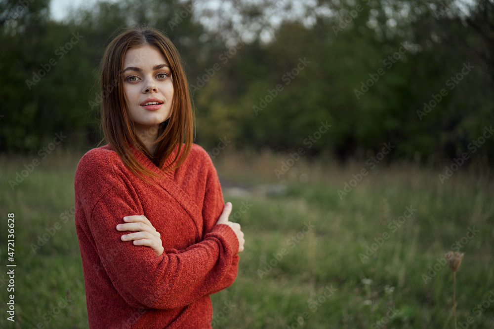 woman in a red sweater outdoors in the field nature rest woman in a red sweater outdoors in the field nature rest