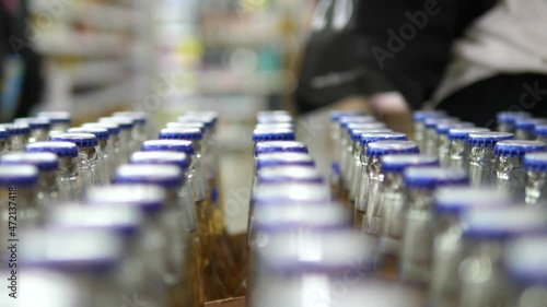 Wallpaper Mural Hand with a ring of a customer taking couple bottles of beer from the row  Torontodigital.ca