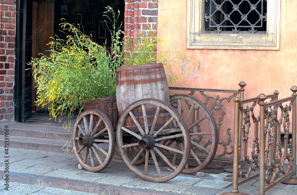 Antique country flower wagon with spoked wheels and barrel.  Warsaw Poland