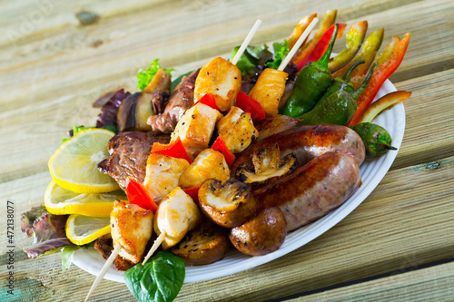 Plate of dish bulgarian cuisine meshana scara with different grilled meat and vegetables photo