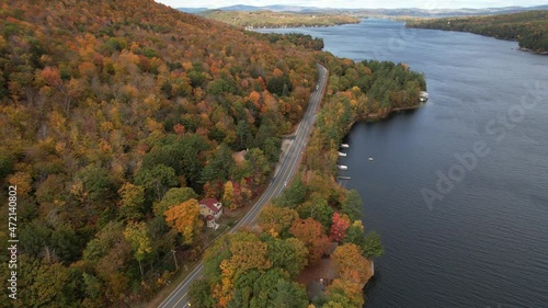 Lake Sunapee Coastline on Autumn, Aerial View of Colorful Foliage, Cars on Road and Lakefront Houses, Drone Shot photo