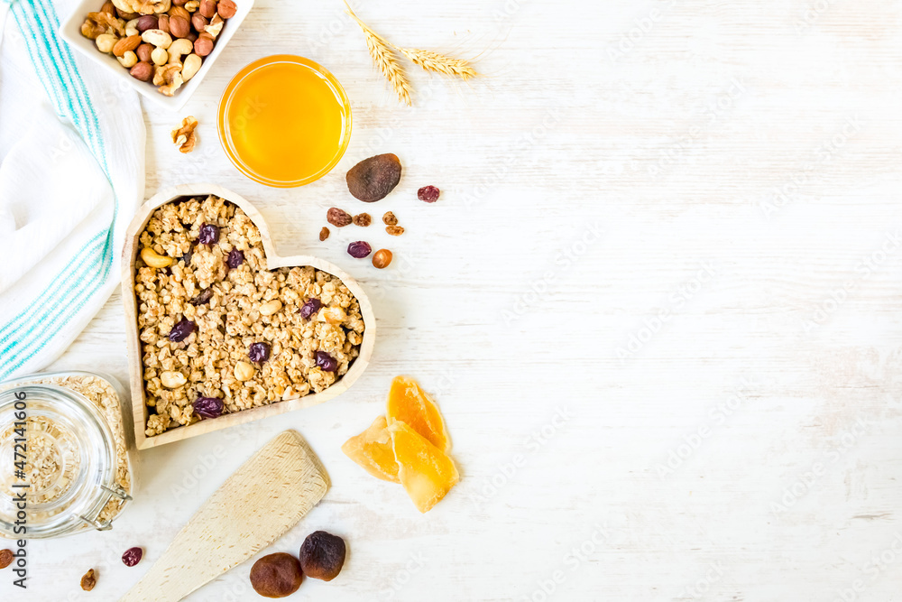 Top view of a heart shaped bow full of crunchy granola. Healthy eating concept. Copy space.
