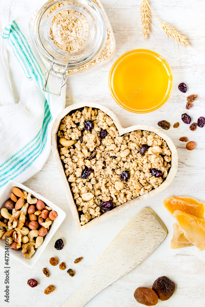 Top view of a heart shaped bow full of crunchy granola. Healthy eating concept.