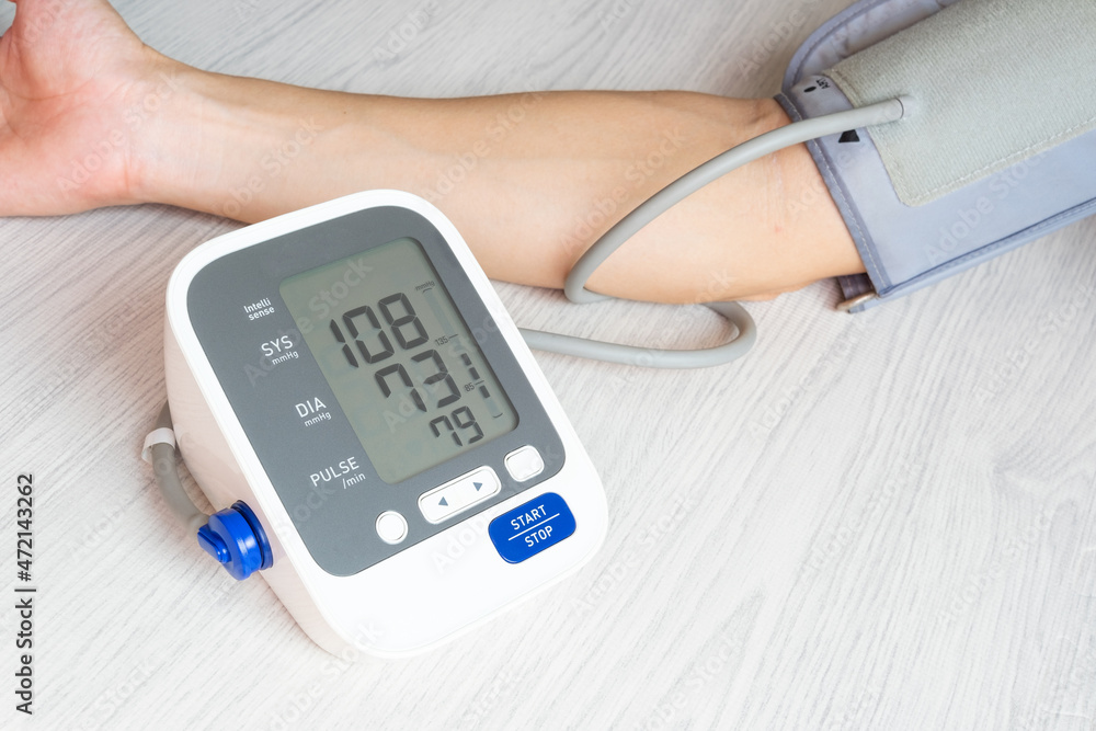 Man check blood pressure monitor and heart rate monitor with digital pressure gauge. Health care and Medical concept Man check blood pressure monitor and heart rate monitor with digital pressure gauge. Health care and Medical concept