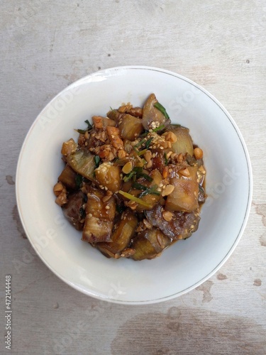 Sauteed eggplant cooked with shallots, garlic, pepper, salt, sugar and sweet soy sauce. In addition to eggplant, added tempeh and scallions. Indonesian food.