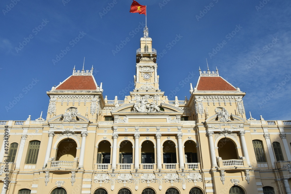 Low Angle Center Facade Detail of People's Committee of Ho Chi Minh City with Flag in Bright Morning Light