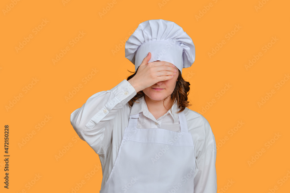 Confused woman chef is sad with hands to face on studio background, mockup copy space Confused woman chef is sad with hands to face on studio background, mockup copy space
