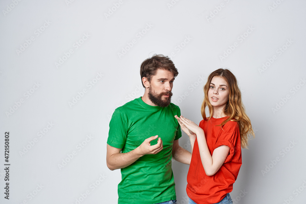 Fototapeta premium married couple multicolored t-shirts communication quarrel isolated background