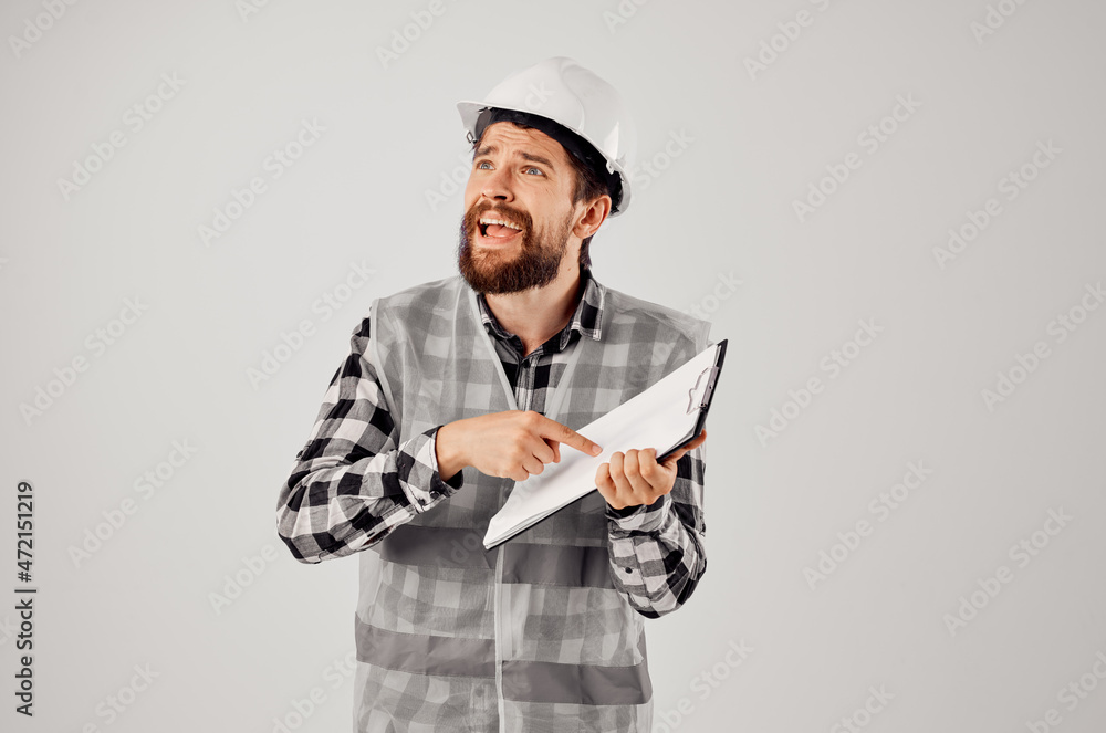 engineer in a white helmet blueprints Professional light background engineer in a white helmet blueprints Professional light background