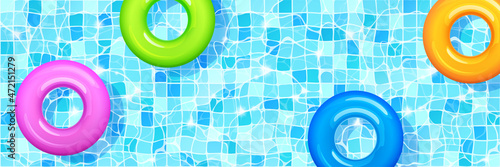 Swimming pool with colorful inflatable rings floating on clean water surface over tiled floor, hotel, summer vacation background design, horizontal template for banner Realistic 3d vector illustration