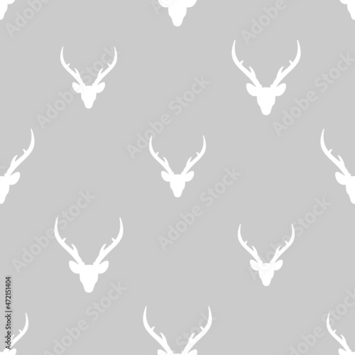 seamless winter pattern with white silhouette of deer head with antlers. vector flat Christmas ornament