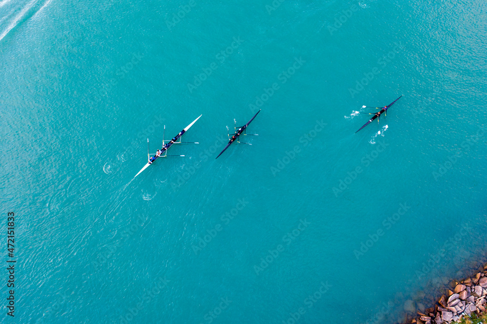 Rowing crews training hard on the Detroit River.