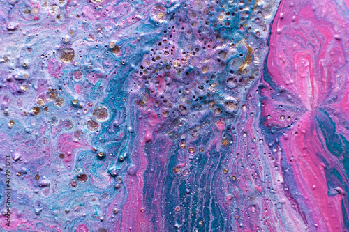 Fluid Art. Embossed mixing, craters and drips of pink and turquoise paint. Marble effect background or texture