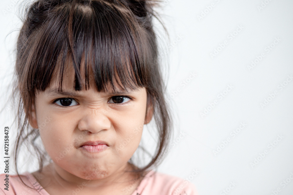 Angry little girl over white background, sign and gesture concept Angry little girl over white background, sign and gesture concept