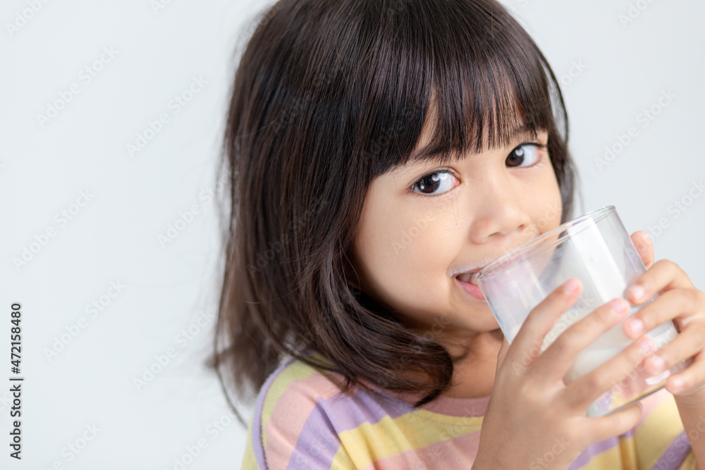 Smiling of Asian girl with a glass of milk Smiling of Asian girl with a glass of milk