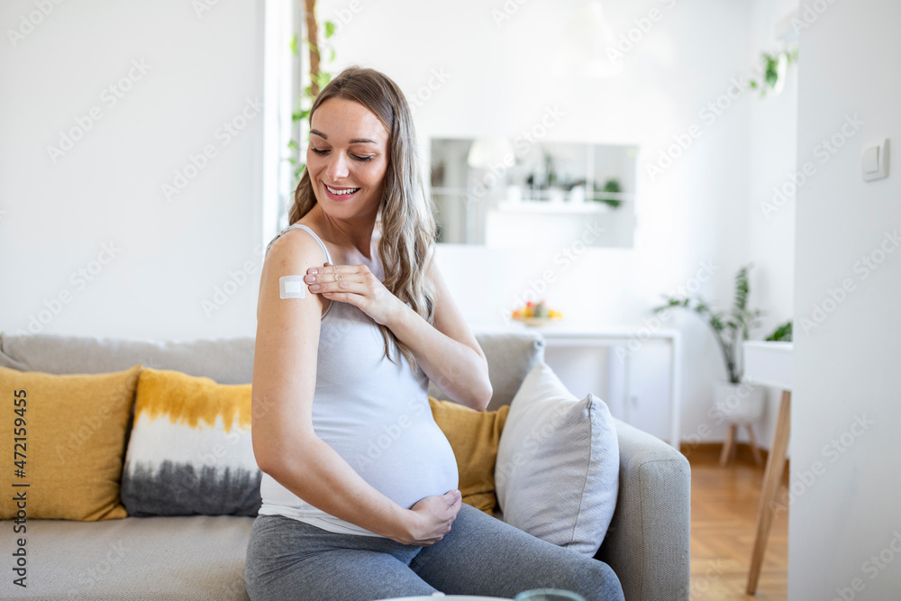Adhesive bandage on arm after injection vaccine or medicine,ADHESIVE BANDAGES PLASTER - Medical Equipment,Soft focus Adhesive bandage on a Pregnant female brachium after covid-19 vaccination Adhesive bandage on arm after injection vaccine or medicine,ADHESIVE BANDAGES PLASTER - Medical Equipment,Soft focus Adhesive bandage on a Pregnant female brachium after covid-19 vaccination