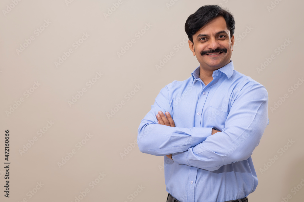 Man in formal dress posing in front of camera with folding hands Man in formal dress posing in front of camera with folding hands