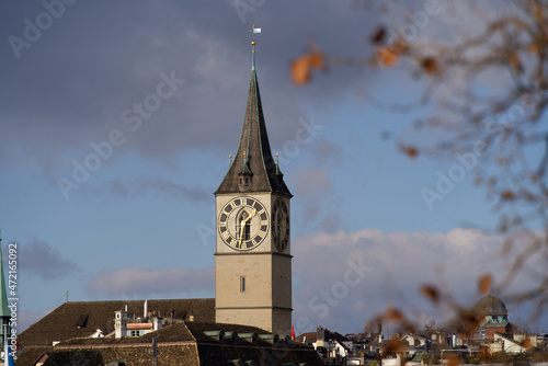 Church tower of protestant medieval church St. Peter at the old town of Zürich on a late autumn cloudy autumn. Photo taken November 29th, 2021, Zurich, Switzerland.