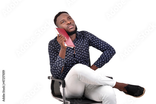 young businessman is holding notebook while thinking.