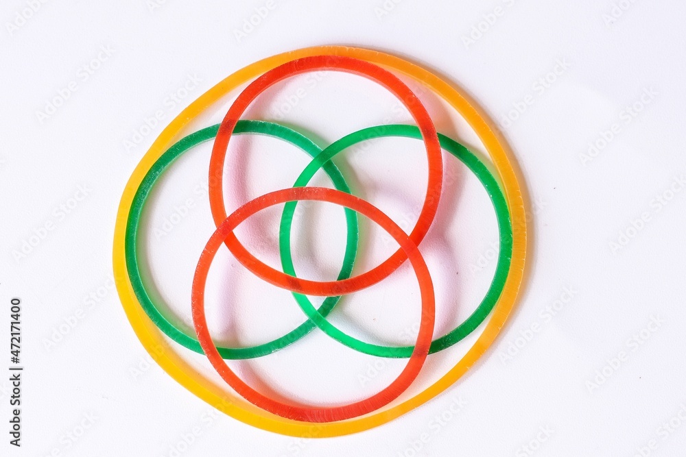Circle rubber bands in a variety of bright colors on a white background. Circle rubber bands in a variety of bright colors on a white background.