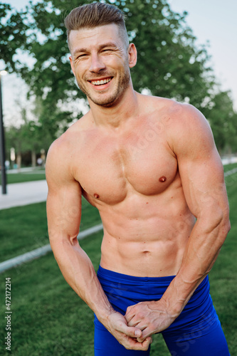 sporty muscled man with naked torso in a workout park © VICHIZH