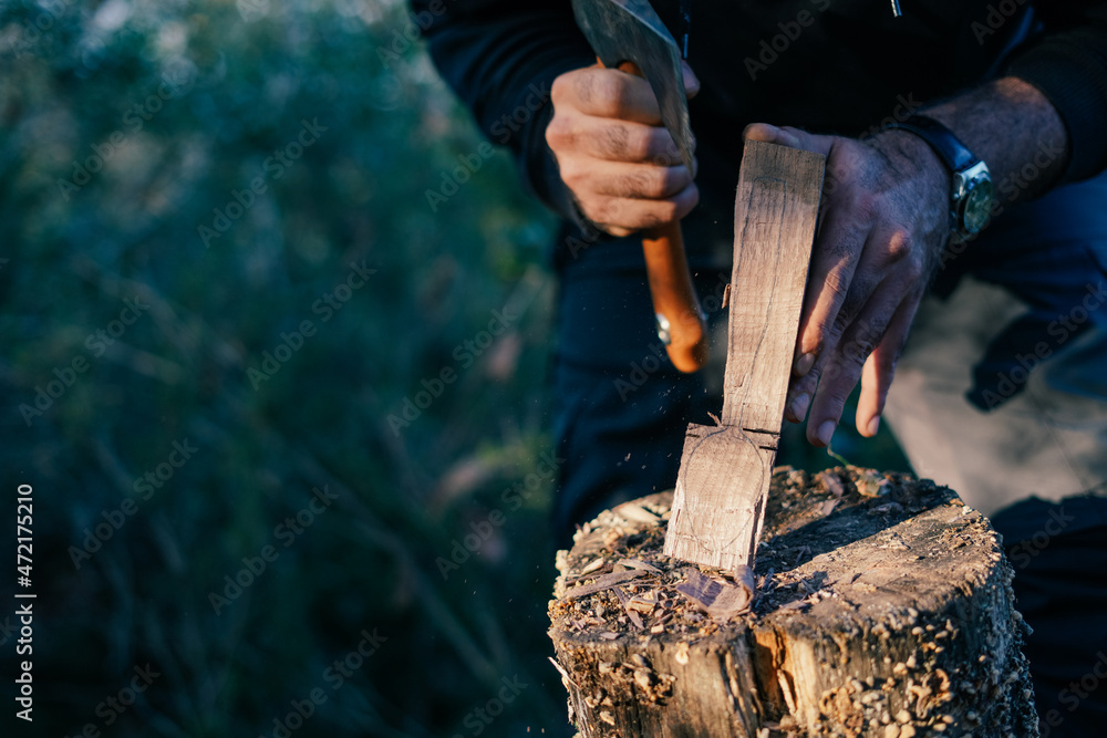 Woodcarving. Manufacturer of wooden kitchen cutting spoon. Male hands with the tools for wood carving.