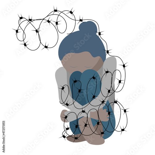 depressive sad person sitting in barbed wire
