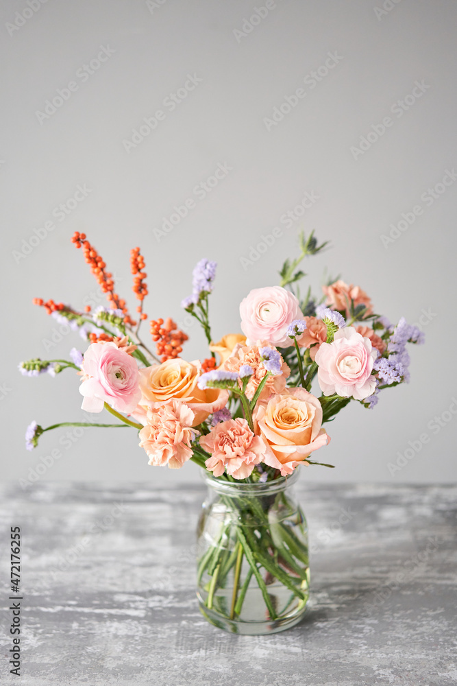Finished flower arrangement in a vase for home. Flowers bunch, set for interior. Fresh cut flowers for decoration home. European floral shop. Delivery fresh cut flower.