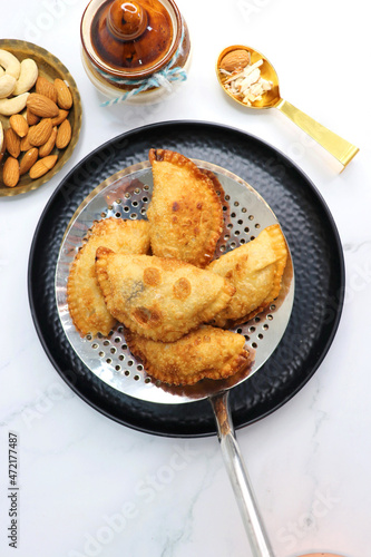 Indian Holi snack popuraly known as Gujia or Gujiya. Also called Karanji in Maharashtra, mostly eaten during Diwali. It is a deep fried sweet dish made from maida and stuffed with khoya or rava. copy. photo