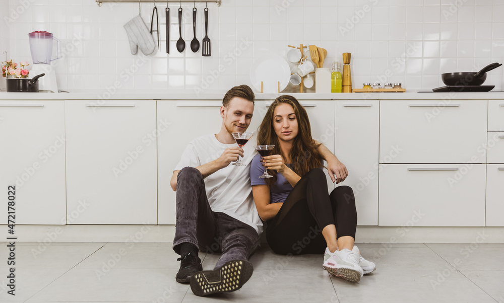 Couple drinking wine in kitchen Couple drinking wine in kitchen
