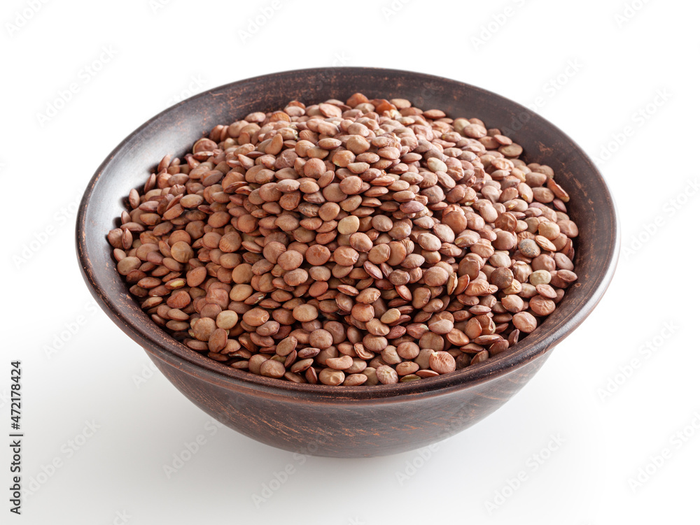 Uncooked lentils in ceramic bowl isolated on white background with clipping path Uncooked lentils in ceramic bowl isolated on white background with clipping path