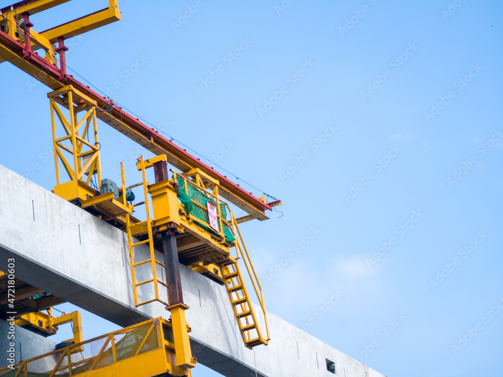 Double Girder overhead crane mounted on a monorail. building railroad tracks The background is the morning sky. Double Girder overhead crane mounted on a monorail. building railroad tracks The background is the morning sky.