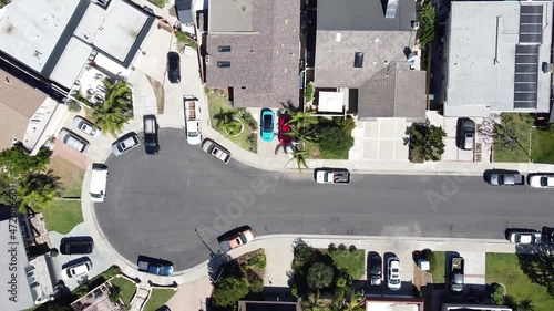 Aerial shot of a cul-de-sac and a road in an rich suburban neighborhood on a sunny day. Huntington Beach, California, USA. photo