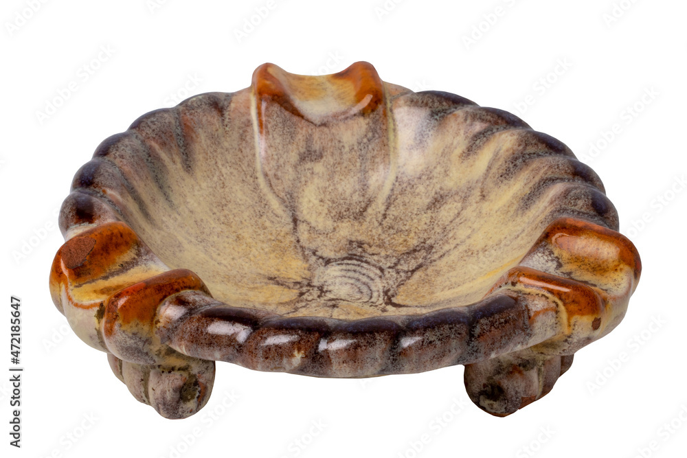 Antiques and art. Close-up of an ancient red brown ceramic ashtray isolated on a white background. Macro. Antiques and art. Close-up of an ancient red brown ceramic ashtray isolated on a white background. Macro.