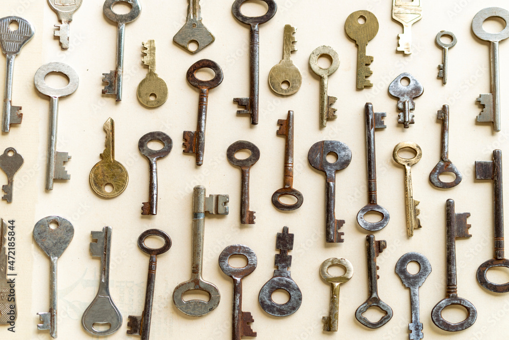 Antique keys are commonly reffered to as a bit or barrel keys, the former having a solid shrank and the latter being hollow. Here are some old antique and vintage keys against paper background. Antique keys are commonly reffered to as a bit or barrel keys, the former having a solid shrank and the latter being hollow. Here are some old antique and vintage keys against paper background.