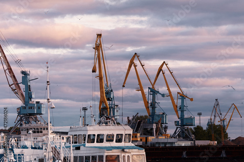 Port cranes in the harbor at sunset. River port in Kazan, Russia. Port dock.