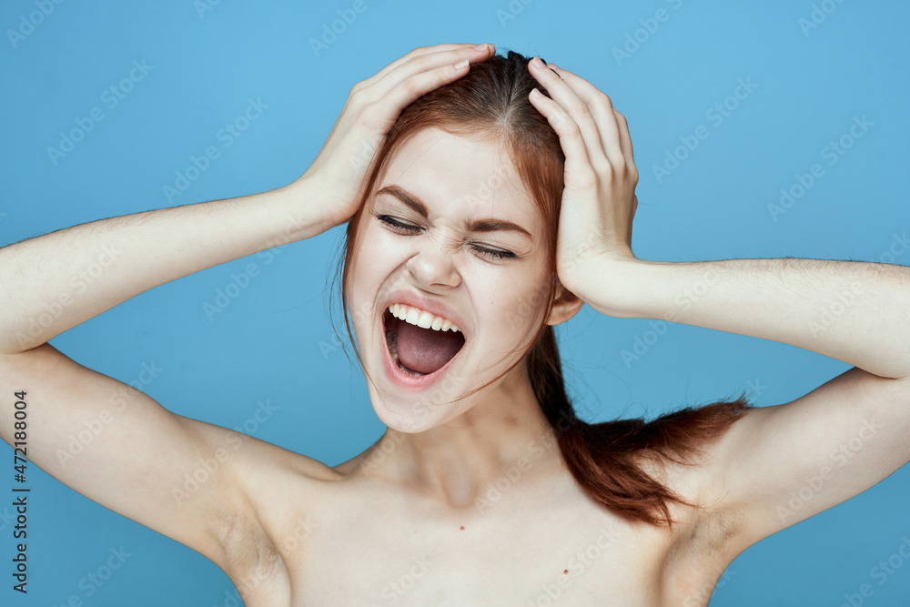 woman with bared shoulders pigtail emotions posing blue background woman with bared shoulders pigtail emotions posing blue background