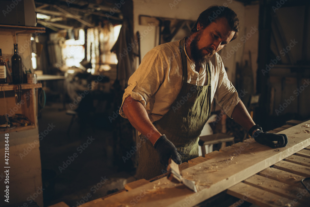 Male joiner at the workplace. High quality photo Male joiner at the workplace. High quality photo