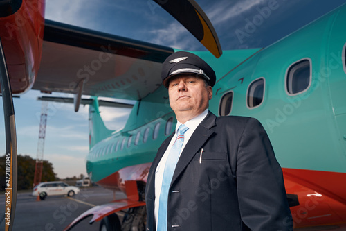 Proud pilot staring down at camera next to his aircraft © Viacheslav Yakobchuk
