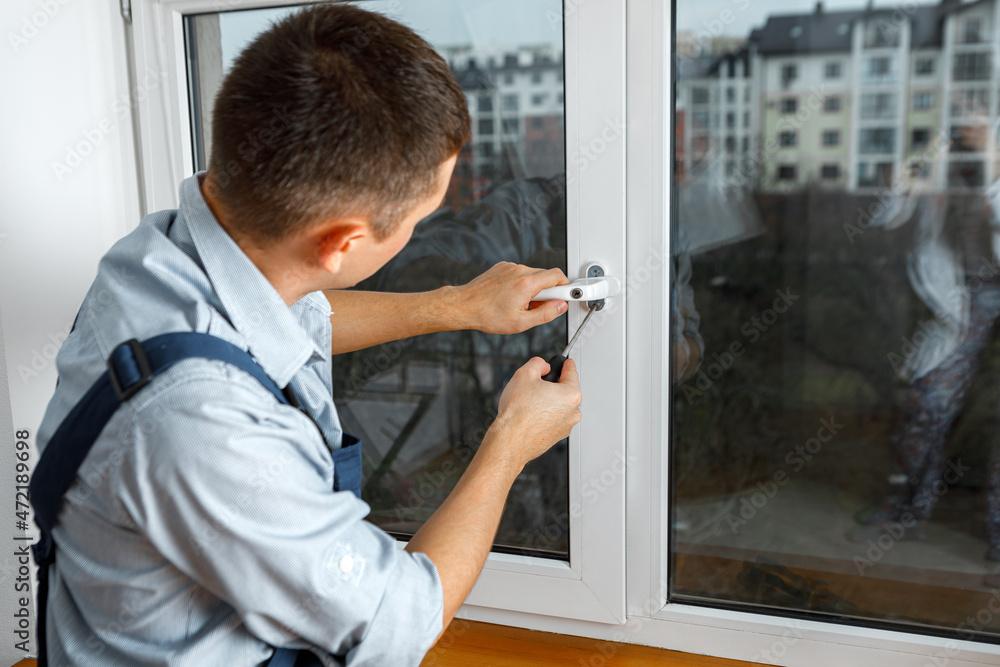 The worker installing and checking window in the house The worker installing and checking window in the house