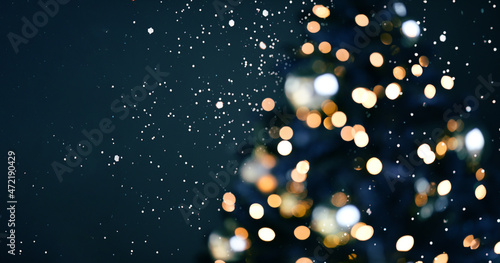 Blurred background. Christmas background with lights. Holiday light bulbs. Blurred silhouette of a Christmas tree