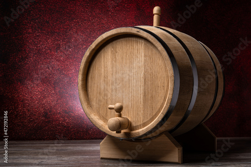 Wood barrel in pub on wooden table and dark red background