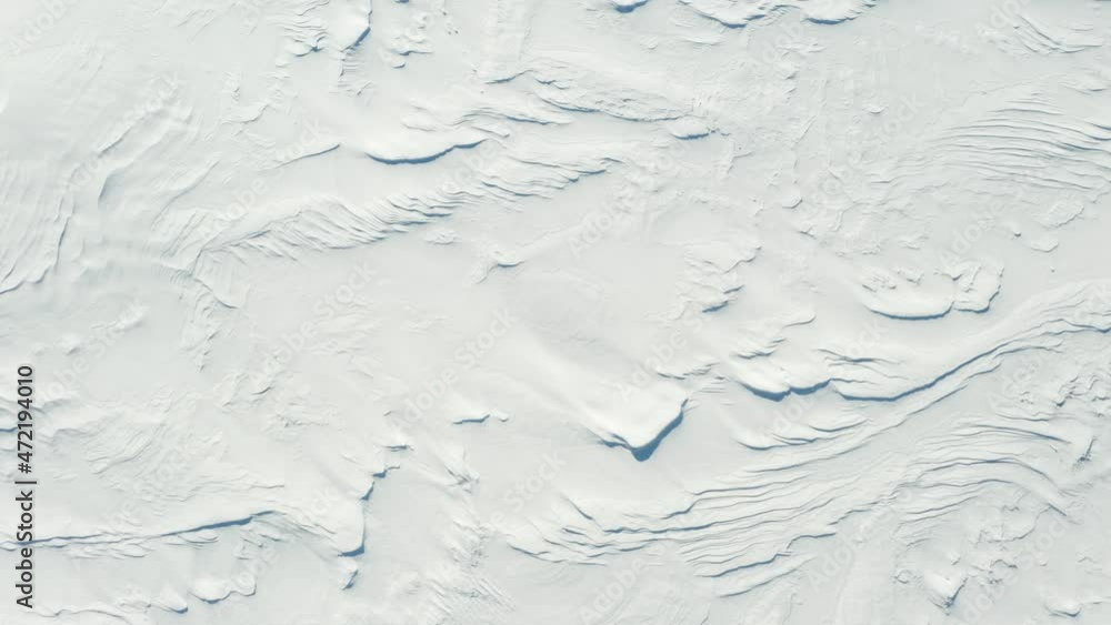 White background of snow texture, aerial view. Birdseye drone shot flying over snow covered frozen field.
White background of snow texture, aerial view. Birdseye drone shot flying over snow covered frozen field.