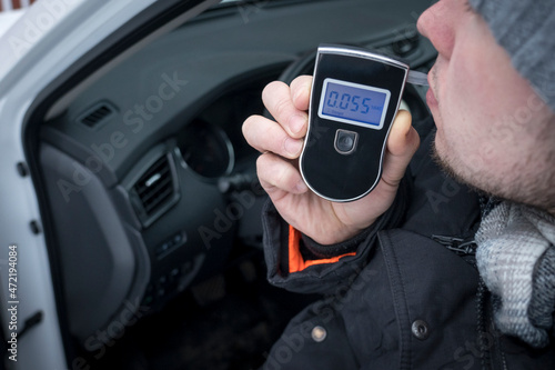 Obraz na plátně a man with a breathalyzer in the car, testing for alcohol and drug intoxication