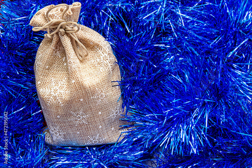 Natural packaging of a tranny bag on a background of tinsel photo