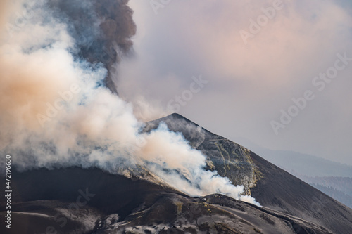 Thick smoke covering active volcano against cloudy sky
