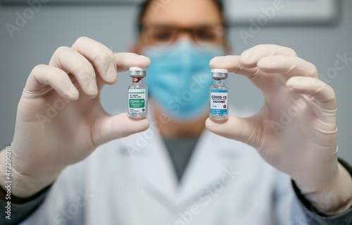 Female doctor showing two coronavirus vaccine options